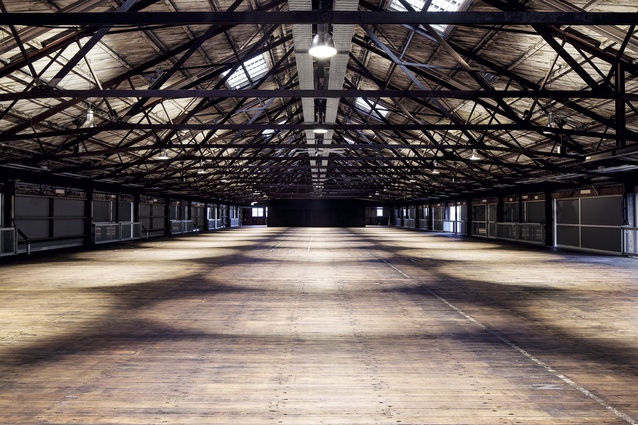 The upper floor features exposed steel roof trusses, a sarked timber ceiling and a patina-rich matai floor.