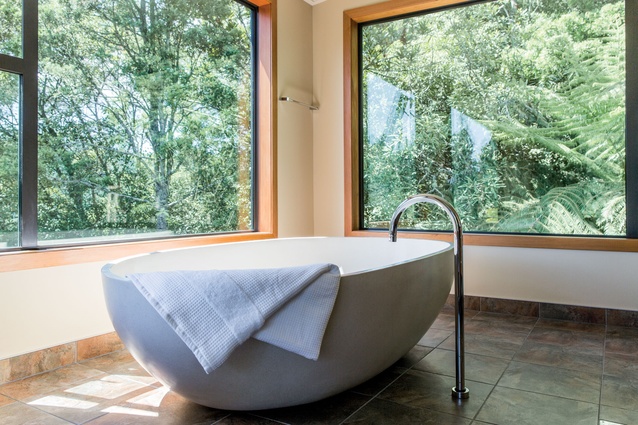 A large bath is the focal point of the minimalist ensuite, designating the space as a zone for relaxation.