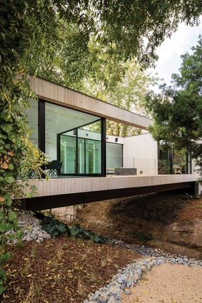 The house quite literally bridges a natural stream.