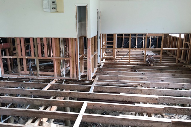 The floors, lining, insulation and fittings of a house are removed following flood damage.