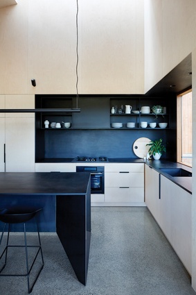 The neatly designed kitchen is tucked into the eastern corner of the main living space.