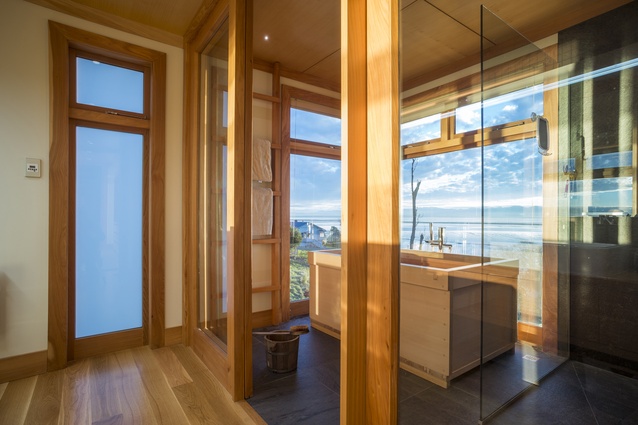 Glazed doors and panels separate the wet and dry zones of the bathroom. 