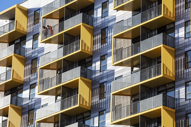 The residential tower features distinctive yellow zig-zagging balconies. The pattern of bricklaying is referenced by the balcony articulation  to the east and west façades. 