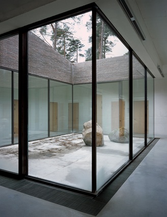 Staff rooms are clustered around the glass-walled courtyard behind the ceremonial areas of the complex.
