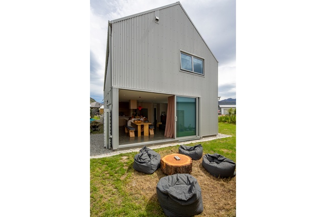 External stacking sliders allow the living room to open to the outdoors. As the house has
close neighbours, upstairs windows are limited and carefully placed.