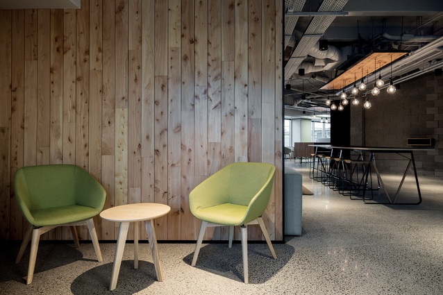 The colour palette at Heartland Bank’s new headquarters merges industrial with home comfort. Brek chairs from Harrows Contract Furniture are seen in the foreground. 