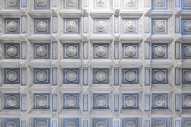 The gentle colouring of the coffered ceiling reflects the coloured glass of the nave windows.
