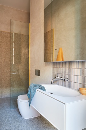 A new bathroom continues the muted palette of materials and colours seen in the main living areas.