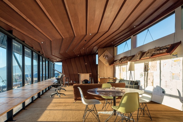 The folding ceiling references neighbouring hills and is constructed in quarter and crown cut mahogany. O’Sullivan designed and built the timber furniture; the workbench against the window is a Miesian detail. 
