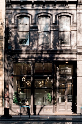 The tagline on the front window, ‘Feel all the Feelings’, is embossed in tight, gold lettering across the black-gloss 19th-century façade. 
