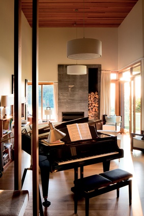 At the end of the music and living room space is a smaller, single-height library nook with a grand piano at its centre.
