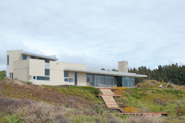 The Peka Peka house sits elevated against the surrounding dunes.