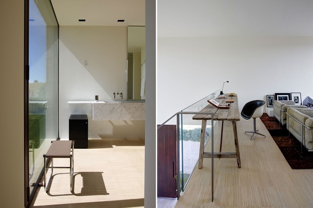 A bathroom is flooded with light thanks to floor-to-ceiling glazing; the mezzanine level is used as a study and library.
