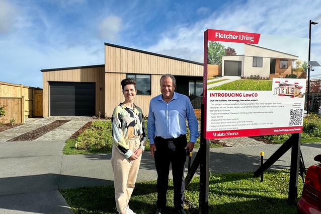 Nicola Tagiston and Steve Evans from Fletcher Living in front of a LowCO home, at Waiata Shores, in Auckland.