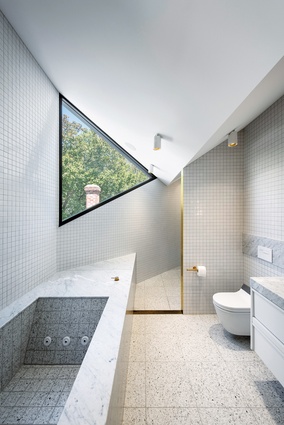 The ensuite makes a bold statement, with its triangular window and custom spa.