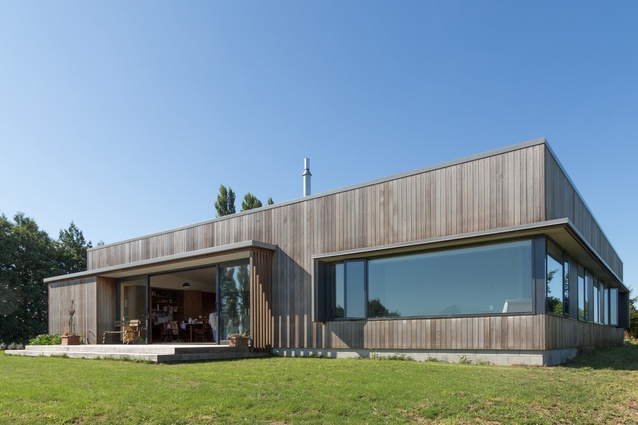 Maniatutu Road residence. The home is situated on an elevated promontory with distant coastal views toward Motiti Island and Mount Maunganui. 