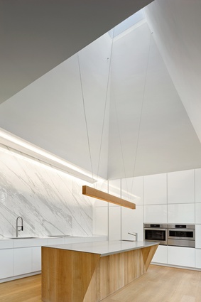 With a large polished Calacatta marble splashback, this kitchen sits at the south end of the home. It features a six-metre-tall pyramidal ceiling.