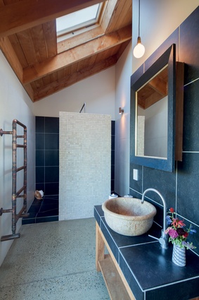 Water heated by the furnace circulates through the custom towel rail, keeping towels warm and dry.
