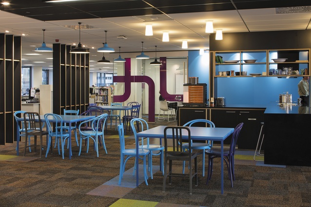 A typical ‘hub’ with cruciform-shaped kitchenette surrounded by a variety of colourful furnishings to create a bright, inviting place for working and socialising. Each floor was given a separate identity through individual colour themes in this central space, with the furniture, light fixtures, and graphics all reflecting the theme.