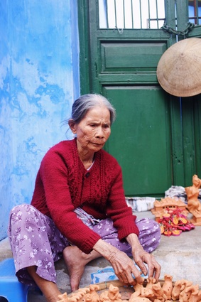 This photo of a woman selling terracotta whistles in Hoi An, Vietnam inspired Kim's mood board.