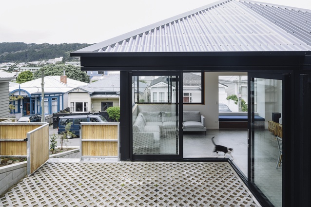 Connected by a central sheltered courtyard, Pyramid Scheme has floor-to-ceiling sliding doors on the ground level that thread together the kitchen, living and courtyard.
