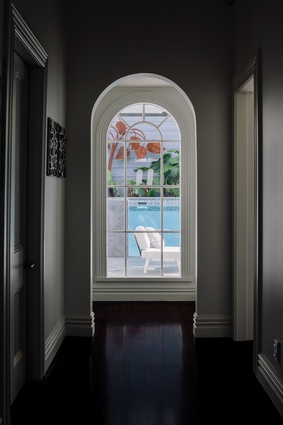 An arched Victorian window draws the eye down the hall.