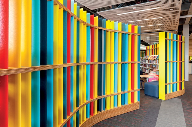 A colourful dividing wall creates a children’s reading area.
