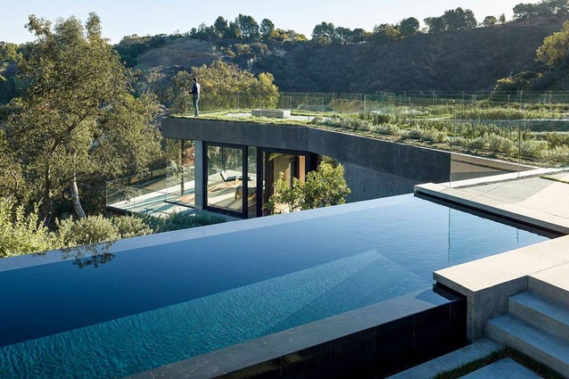 The master bedroom is seen beyond the pool.