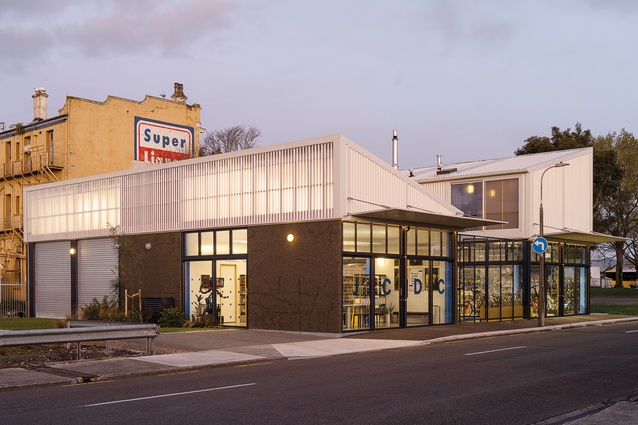 View from the corner of Main and Domain Streets. This building is light, blue, see through: a light box on the corner.