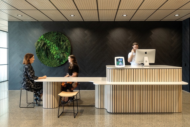 In the lobby of DDB a ‘welcome kiosk’ is positioned against a black herringbone vinyl feature wall.