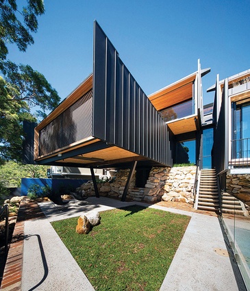 The home’s series of interconnected, cantilevered forms, conceived as seed pods, cascades down the steeply sloping site.