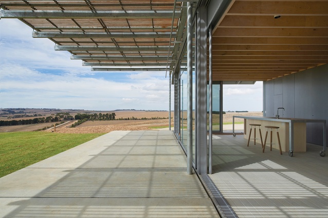 The parallel planes of ground and parasol frame uninterrupted views of the landscape from the kitchen and living spaces.