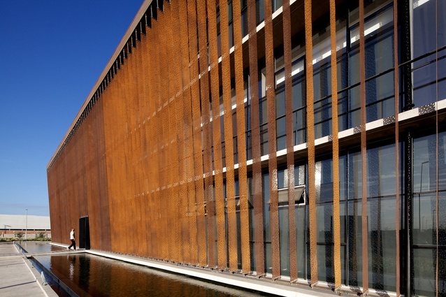 Ferreteria O'Higgins by GH+A and Guillermo Hevia. Situated in Chile, 2011. Perforated Corten steel sheets move in the wind, creating a dynamic dimension to the building.