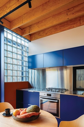 The south-facing glass block wall infuses the kitchen with diffused light.