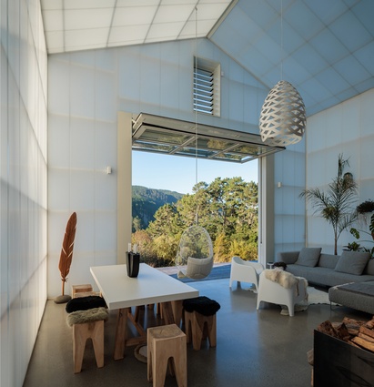 Inside the outside space, the outdoor living room features a 5.5m stud and large operable openings. The aircraft hanger-style door pulls up to maximise outdoor connections.