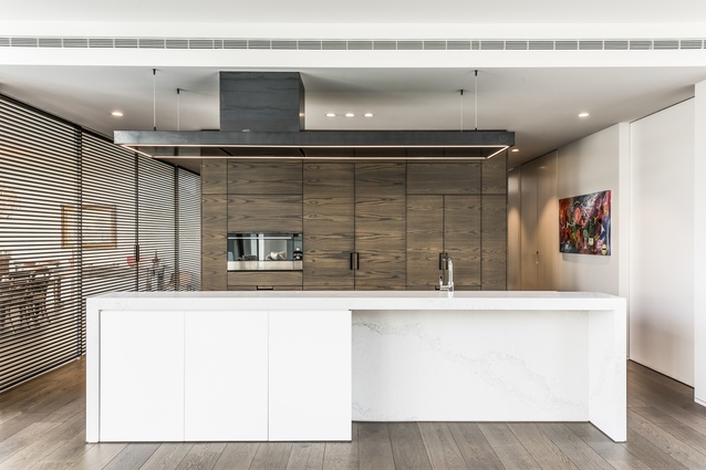 This large, modern kitchen features Fisher & Paykel appliances that accentuate the kitchen's strong architectural form and boldness of the design.