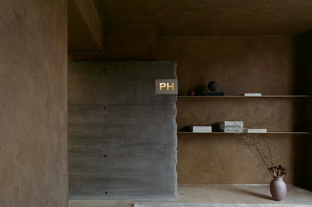The entry — warm and raw — intimately welcomes works and clients.
