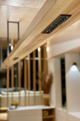 The hanging light above the dining table is made from American ash to mirror the table below.