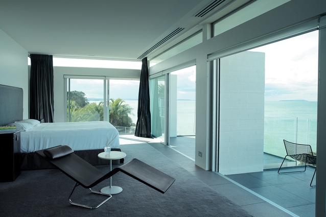 On the upper level the main bedroom gives out onto small terraces, and looks northeast across the Gulf to Rangitoto.