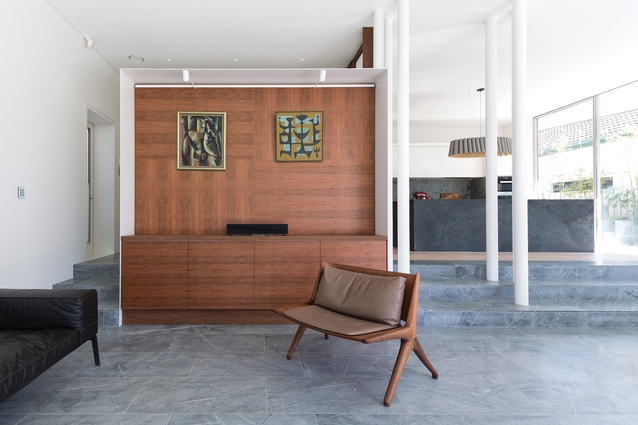 Three main cabinetry units (including this one in the living room) are framed in white metal. Artwork: Leonard French (left); John Coburn (right).