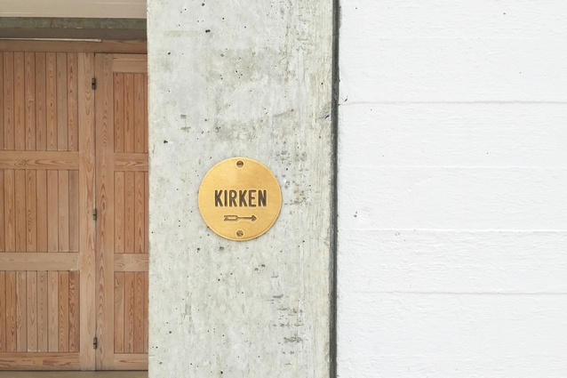 Signage is in the form of small, round brass plates.