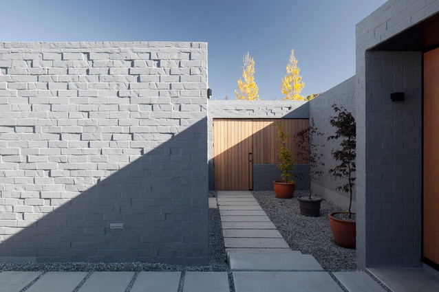 Lake Hawea Courtyard House. The use of 'seconds bricks' laid randomly encourages texture that complements the surrounding natural landscape.