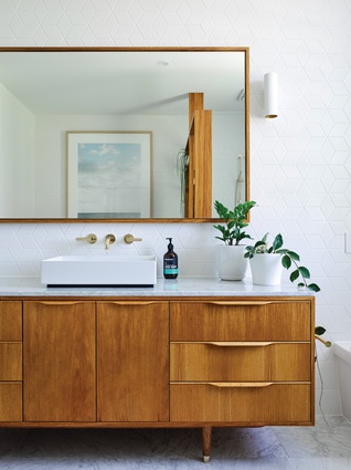 Fine timber detailing with a modernist aesthetic is applied to bathroom joinery.
