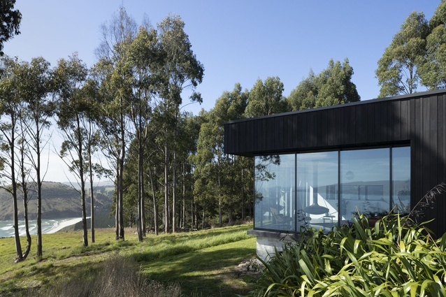 Generous floor-to-ceiling windows in the living area help it appear to float within the surrounding scenery.
