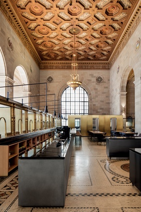 The building boasts an opulent stucco ceiling, copious solid-brass fixtures and enormous arched windows.