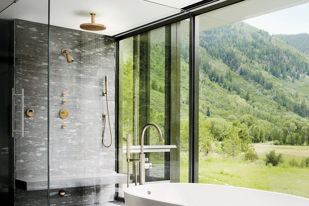 Copper shower and bath fittings add warmth to this outdoor-style space.