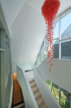 An organic pendant light hangs over the stairwell. 