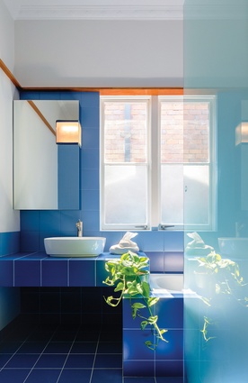 The new three-way bathroom, lavatory and laundry is tiled in soothing blue duotones.