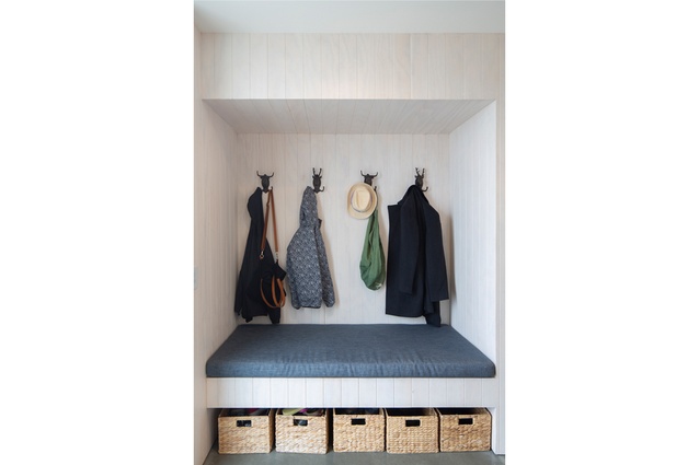 Built-in seating features in the entry foyer and living room. This is formed from the same
whitewashed v-groove ply used on the lower level walls.