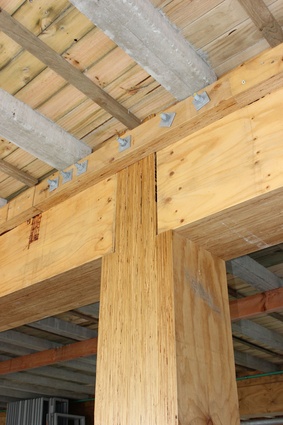 Rebated columns seat floor beams, enabling a simple bolted corbel to hold the floor, beams and posts in location. 